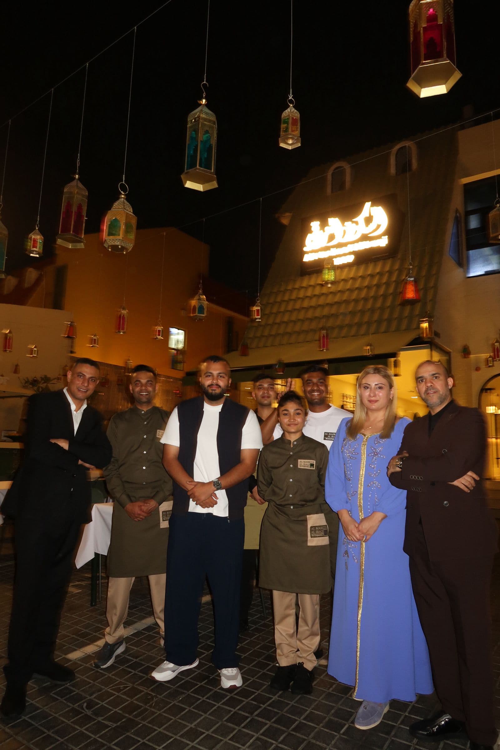 Khattab Omar with guests and team under the lanterns